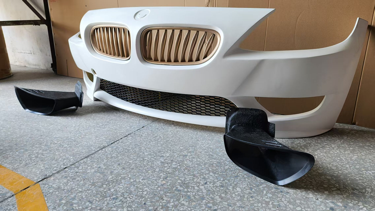 Angled view of BMW Z4 M-Style front bumper with Skyer brake air duct set installed, fits 2003-2008 Roadster and Coupe